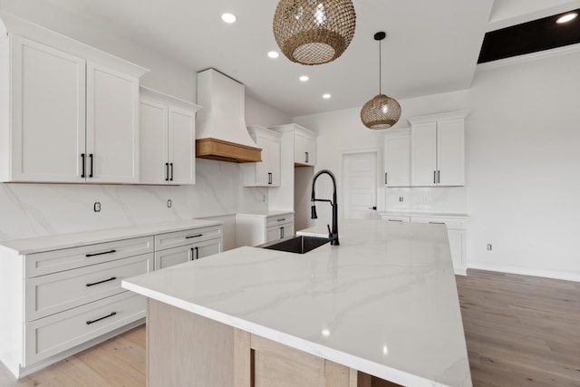 4252 Equestrian Way, Richmond, KY 40475 - kitchen featuring custom range hood, a kitchen island with sink, light wood-type flooring, backsplash, and recessed lighting