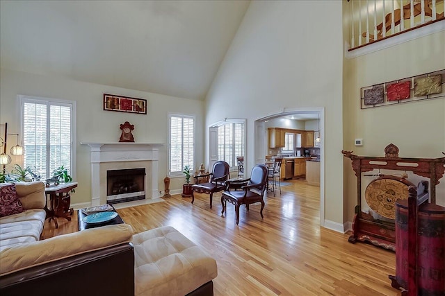 428 Shady Brook Dr, Richmond, KY 40475 - living room with high vaulted ceiling, a high end fireplace, healthy amount of natural light, light wood-type flooring, and arched walkways