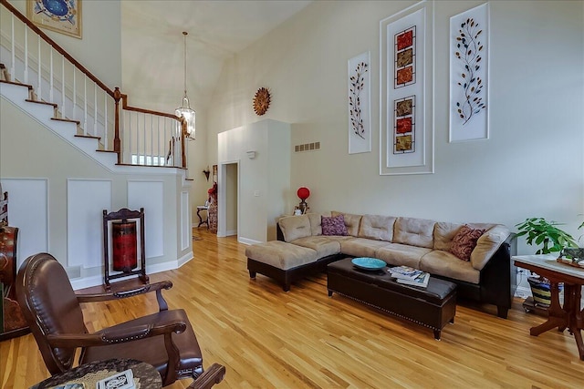 428 Shady Brook Dr, Richmond, KY 40475 - living room with a towering ceiling, light wood-type flooring, stairs, and baseboards