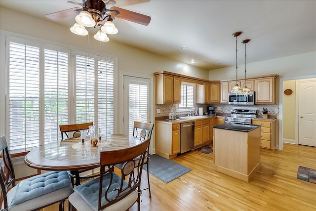428 Shady Brook Dr, Richmond, KY 40475 - kitchen featuring appliances with stainless steel finishes, a sink, ceiling fan, tasteful backsplash, and a kitchen island