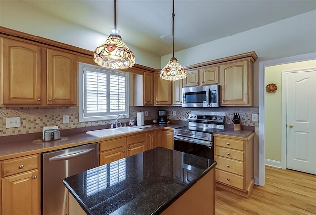 428 Shady Brook Dr, Richmond, KY 40475 - kitchen featuring appliances with stainless steel finishes, a sink, decorative backsplash, pendant lighting, and light wood finished floors