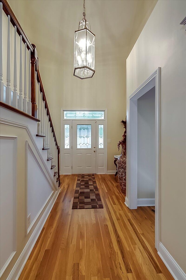 428 Shady Brook Dr, Richmond, KY 40475 - entrance foyer with light wood finished floors, a chandelier, a towering ceiling, stairway, and baseboards
