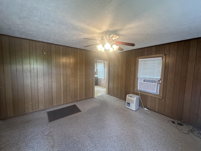 367 N N Estill Ave, Richmond, KY 40475 - empty room featuring ceiling fan, wood walls, a textured ceiling, carpet flooring, and cooling unit