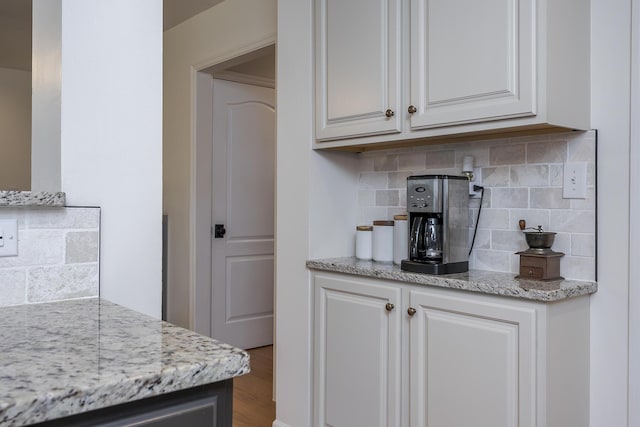 3657 Gladman Way, Lexington, KY 40503 - kitchen with decorative backsplash, light stone countertops, wood finished floors, and white cabinets