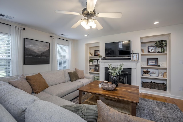 3657 Gladman Way, Lexington, KY 40503 - living area with a fireplace, wood finished floors, a ceiling fan, built in shelves, and recessed lighting