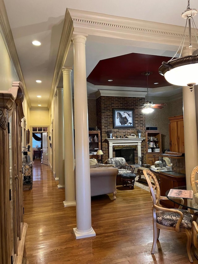 1740 Gose Pike, Danville, KY 40422 - living room featuring wood finished floors, a brick fireplace, ornate columns, crown molding, and ceiling fan