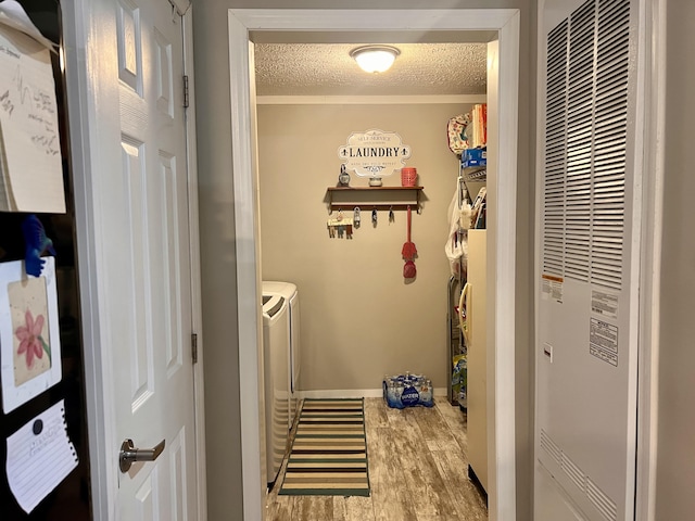233 Bearskin Holw, Morehead, KY 40351 - laundry area with a heating unit, washing machine and dryer, a textured ceiling, wood finished floors, and baseboards