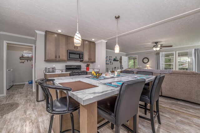 233 Bearskin Holw, Morehead, KY 40351 - kitchen with stainless steel appliances, ornamental molding, open floor plan, a textured ceiling, and washer and dryer