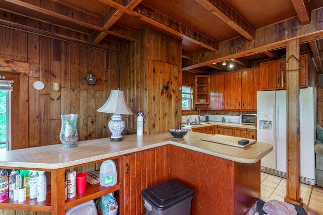274 Oster Dr, Harrodsburg, KY 40330 - kitchen with open shelves, white fridge with ice dispenser, light countertops, stainless steel microwave, and wood walls