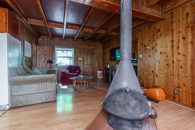 274 Oster Dr, Harrodsburg, KY 40330 - living room with wooden walls, wood finished floors, a wood stove, and wooden ceiling with exposed beams