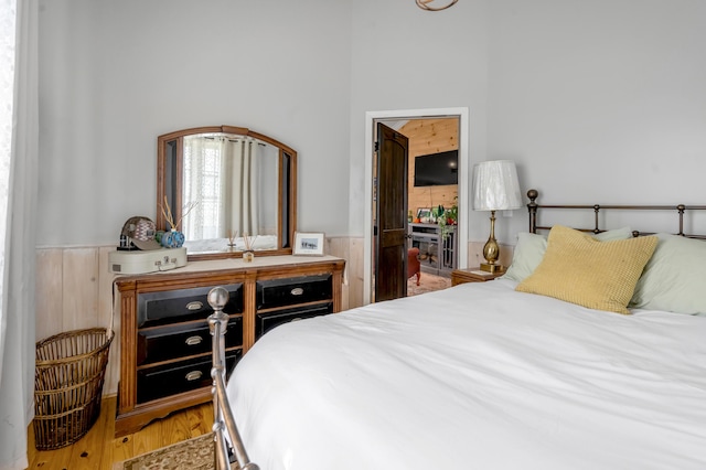 1235 Jackstown Rd, Paris, KY 40361 - bedroom with wainscoting, wood finished floors, and wooden walls