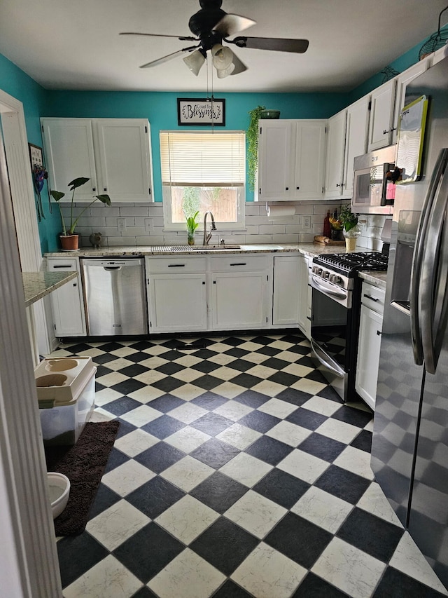 105 Herrington Hwy, Georgetown, KY 40324 - kitchen with stainless steel appliances, light flooring, backsplash, a ceiling fan, and white cabinets