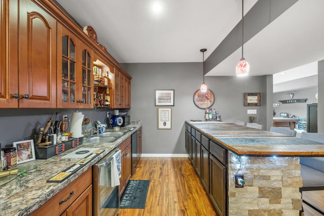 1658 S S Byp, Lawrenceburg, KY 40342 - kitchen featuring dishwasher, a sink, glass insert cabinets, light wood-style flooring, and a breakfast bar area