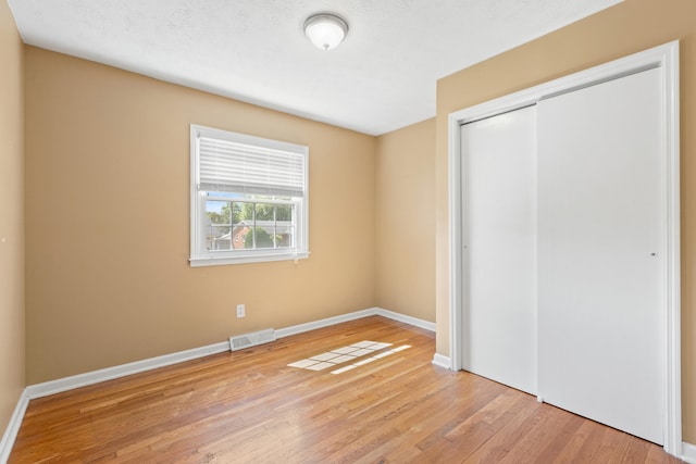 2371 Pierson Dr, Lexington, KY 40505 - unfurnished bedroom with a closet, wood finished floors, and baseboards