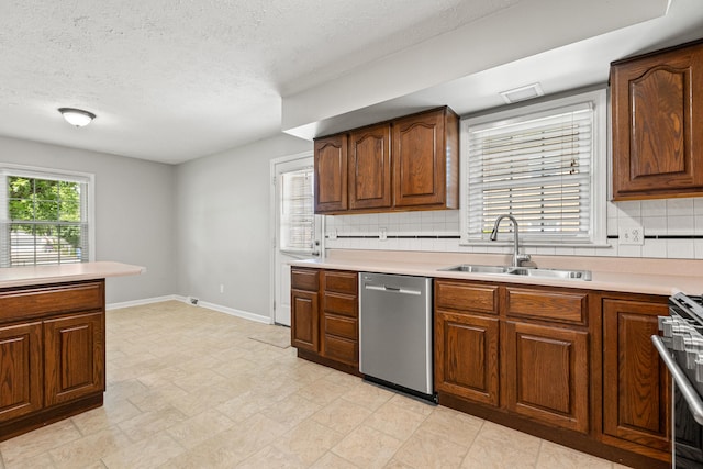 2371 Pierson Dr, Lexington, KY 40505 - kitchen with stainless steel dishwasher, a sink, tasteful backsplash, a textured ceiling, and light countertops