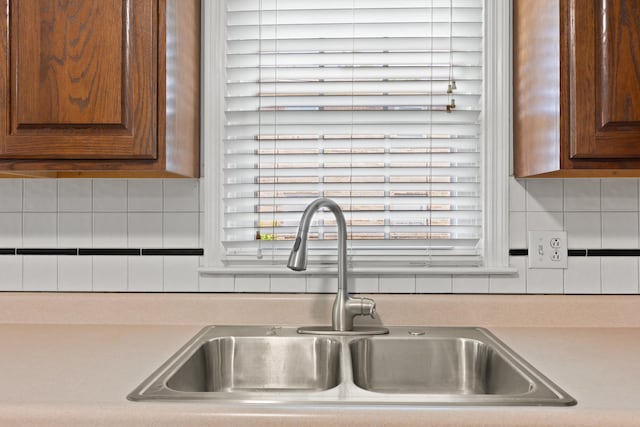 2371 Pierson Dr, Lexington, KY 40505 - kitchen view of a sink, decorative backsplash, light countertops, and brown cabinets
