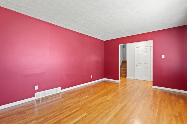 2371 Pierson Dr, Lexington, KY 40505 - spare room with a textured ceiling, wood finished floors, baseboards, and stairs