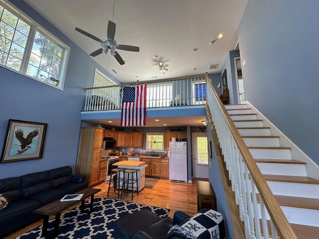 169 Kennedy Ln, Lancaster, KY 40444 - living area featuring a high ceiling, light wood-style flooring, a ceiling fan, stairs, and recessed lighting