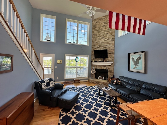 169 Kennedy Ln, Lancaster, KY 40444 - living area featuring light wood finished floors, ceiling fan, stairway, plenty of natural light, and a towering ceiling