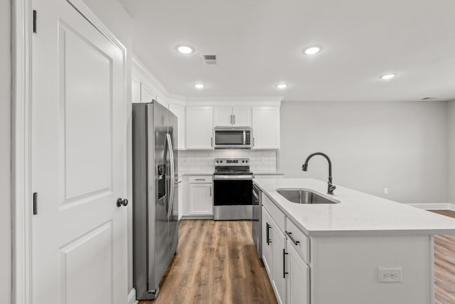 5001/5003 Melana Way, Richmond, KY 40475 - kitchen featuring stainless steel appliances, a sink, light wood-style flooring, white cabinetry, and backsplash