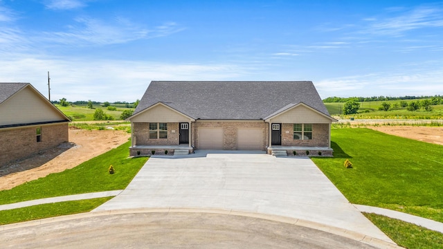 5001/5003 Melana Way, Richmond, KY 40475 - view of front of house featuring driveway, a front yard, a garage, and brick siding