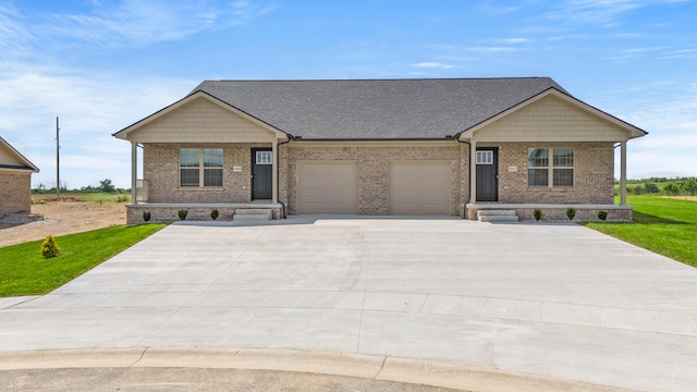 5001/5003 Melana Way, Richmond, KY 40475 - craftsman house with covered porch, an attached garage, brick siding, and driveway
