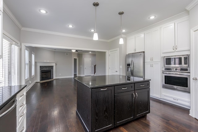 3880 Leighton Ln, Lexington, KY 40515 - kitchen featuring appliances with stainless steel finishes, ornamental molding, white cabinets, dark wood finished floors, and a fireplace with flush hearth