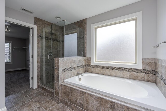 3880 Leighton Ln, Lexington, KY 40515 - bathroom with a garden tub, a stall shower, a walk in closet, and tile patterned flooring