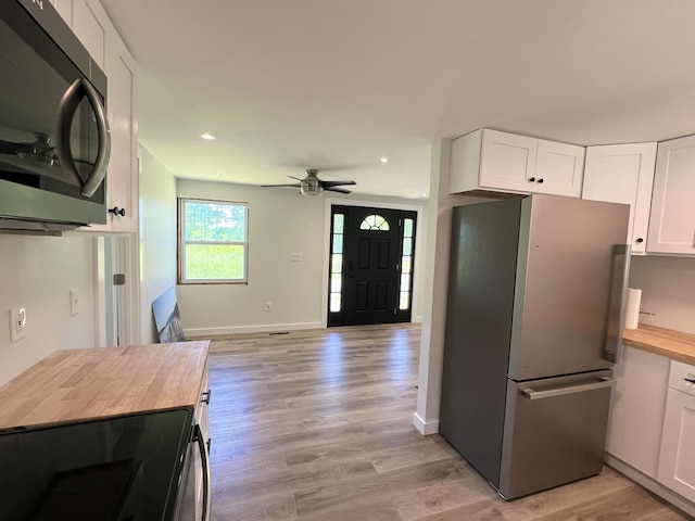 819 Scotts Chapel Rd, Jamestown, KY 42629 - kitchen with appliances with stainless steel finishes, wood counters, white cabinetry, a ceiling fan, and light wood-style flooring