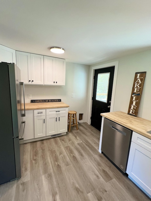 819 Scotts Chapel Rd, Jamestown, KY 42629 - kitchen featuring butcher block countertops, stainless steel appliances, white cabinets, and light wood-style floors