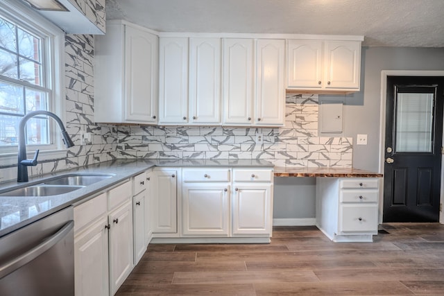 108 Rancho Ct, Frankfort, KY 40601 - kitchen with stainless steel dishwasher, a sink, tasteful backsplash, white cabinets, and wood finished floors
