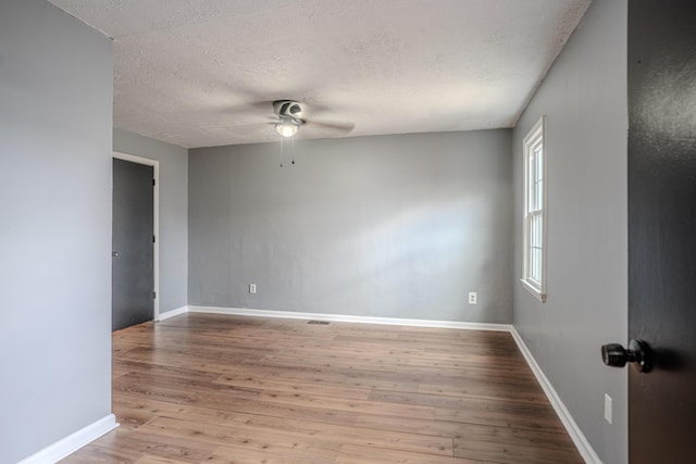 108 Rancho Ct, Frankfort, KY 40601 - empty room featuring a textured ceiling, ceiling fan, wood finished floors, and baseboards
