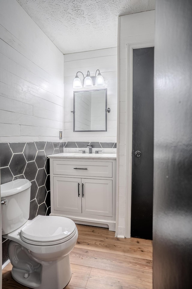 108 Rancho Ct, Frankfort, KY 40601 - half bathroom with toilet, vanity, wood finished floors, and a textured ceiling