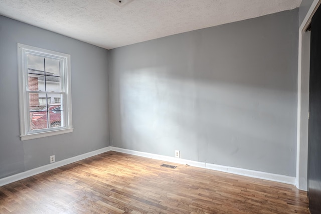 108 Rancho Ct, Frankfort, KY 40601 - unfurnished room with wood finished floors, baseboards, and a textured ceiling