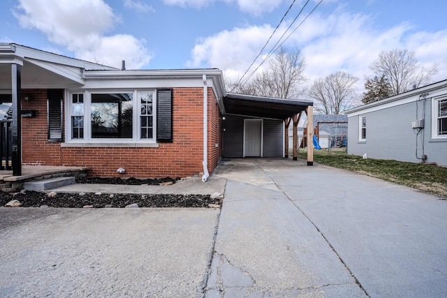 108 Rancho Ct, Frankfort, KY 40601 - view of front of home featuring driveway, brick siding, and a carport