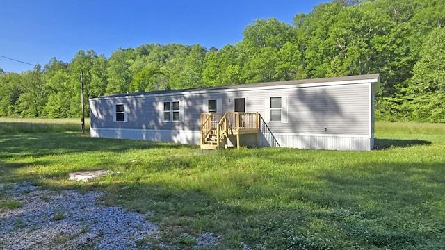 2499 Sacker Rd, Manchester, KY 40962 - back of house featuring a wooded view and a yard