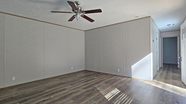 2499 Sacker Rd, Manchester, KY 40962 - empty room with wood finished floors, a ceiling fan, and a decorative wall