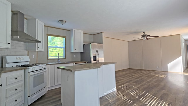2499 Sacker Rd, Manchester, KY 40962 - kitchen featuring white gas range oven, wall chimney range hood, stainless steel fridge, a center island, and ceiling fan