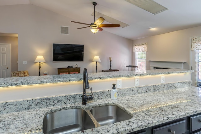 4140 Clearwater Way, Lexington, KY 40515 - kitchen featuring lofted ceiling, a sink, ceiling fan, open floor plan, and a fireplace