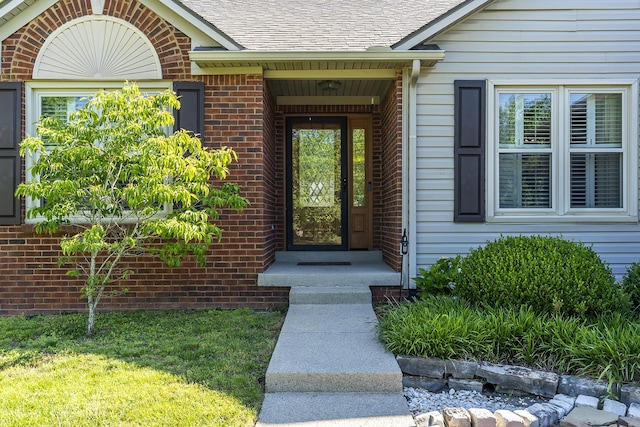 4140 Clearwater Way, Lexington, KY 40515 - entrance to property featuring brick siding, roof with shingles, and a yard
