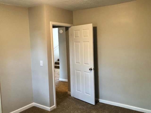 624 Richardson Ln, Frankfort, KY 40601 - empty room with dark carpet, baseboards, and stairway