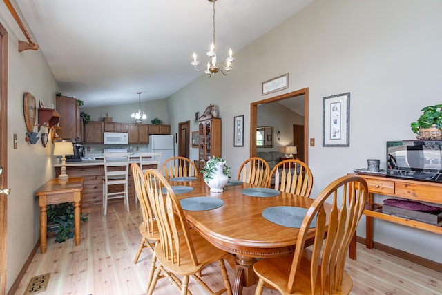428 Patchen Dr, Lexington, KY 40517 - dining space with a chandelier, vaulted ceiling, light wood-style floors, and baseboards