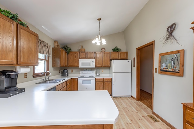 428 Patchen Dr, Lexington, KY 40517 - kitchen with white appliances, a sink, vaulted ceiling, light countertops, and light wood-type flooring