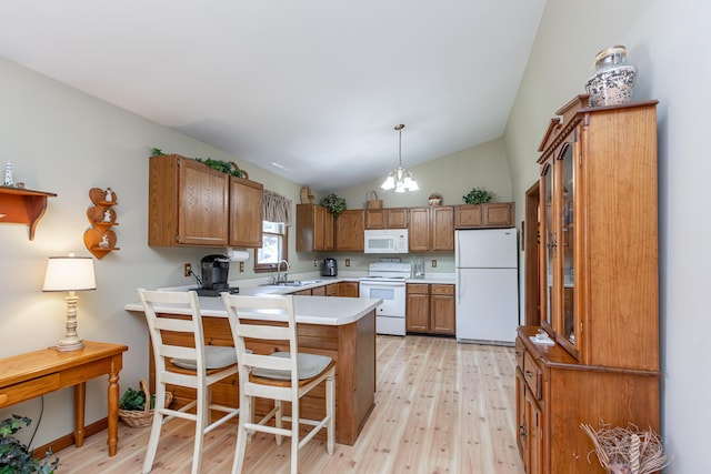 428 Patchen Dr, Lexington, KY 40517 - kitchen with white appliances, a peninsula, light wood-style flooring, lofted ceiling, and brown cabinetry