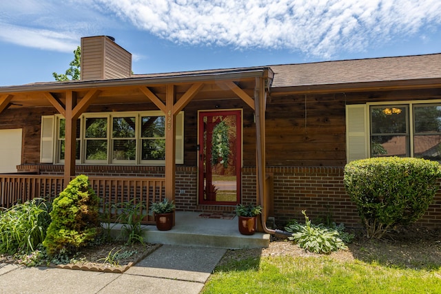 428 Patchen Dr, Lexington, KY 40517 - doorway to property with brick siding, covered porch, and a chimney