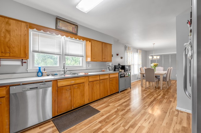 900 Shoshoni Trl, Georgetown, KY 40324 - kitchen with stainless steel appliances, light wood finished floors, a sink, light countertops, and a chandelier