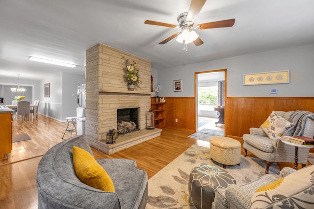 900 Shoshoni Trl, Georgetown, KY 40324 - living area with a wainscoted wall, a ceiling fan, a fireplace, wood finished floors, and a chandelier