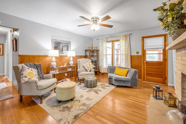 900 Shoshoni Trl, Georgetown, KY 40324 - living area with wainscoting, a fireplace, wood finished floors, a ceiling fan, and wooden walls