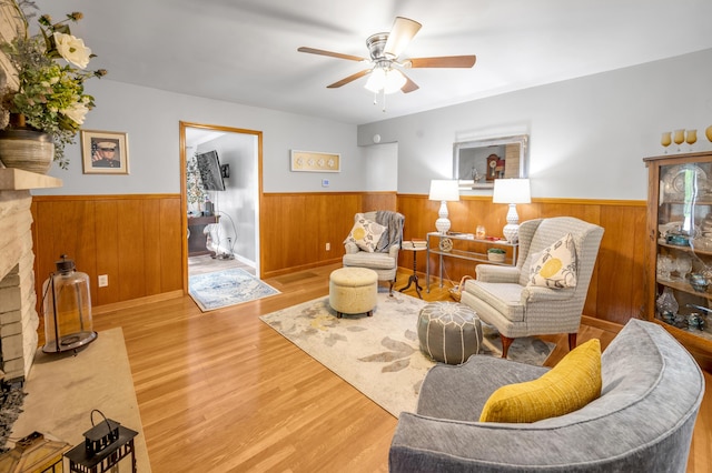 900 Shoshoni Trl, Georgetown, KY 40324 - living room with a wainscoted wall, ceiling fan, wood finished floors, wooden walls, and a fireplace