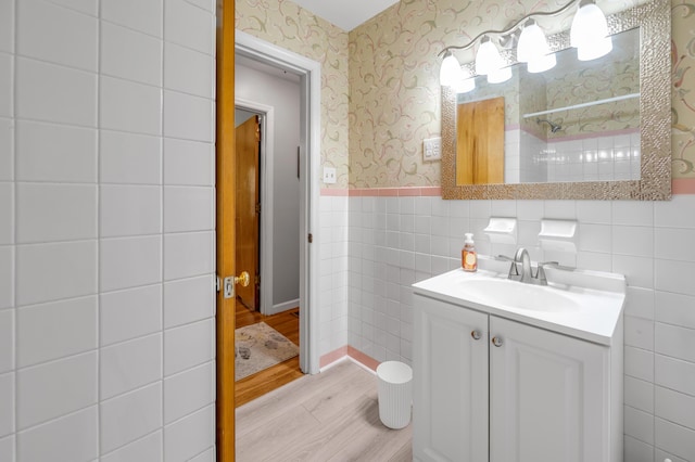 900 Shoshoni Trl, Georgetown, KY 40324 - bathroom with wood finished floors, wallpapered walls, vanity, a wainscoted wall, and tile walls